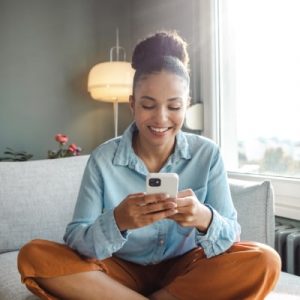 smiley lady sitting and browsing her phone