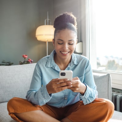 smiley lady sitting and browsing her phone